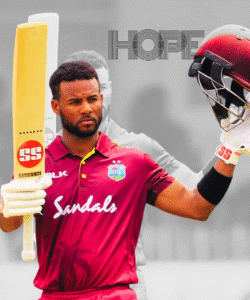 “अंतरराष्ट्रीय मैच में शानदार पारी के बाद बल्ला और हेलमेट उठाकर जश्न मनाते वेस्ट इंडीज के स्टार बल्लेबाज़ की तस्वीर।”