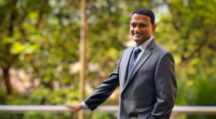 टीसीएस के सीईओ के कृष्णिवासन की पेशेवर तस्वीर, जहां वे सूट पहने मुस्कुराते हुए खड़े हैं। K Krithivasan